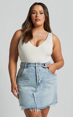 Pieta Mini Skirt - Recycled Cotton Raw Hem Denim Skirt in Mid Blue Wash